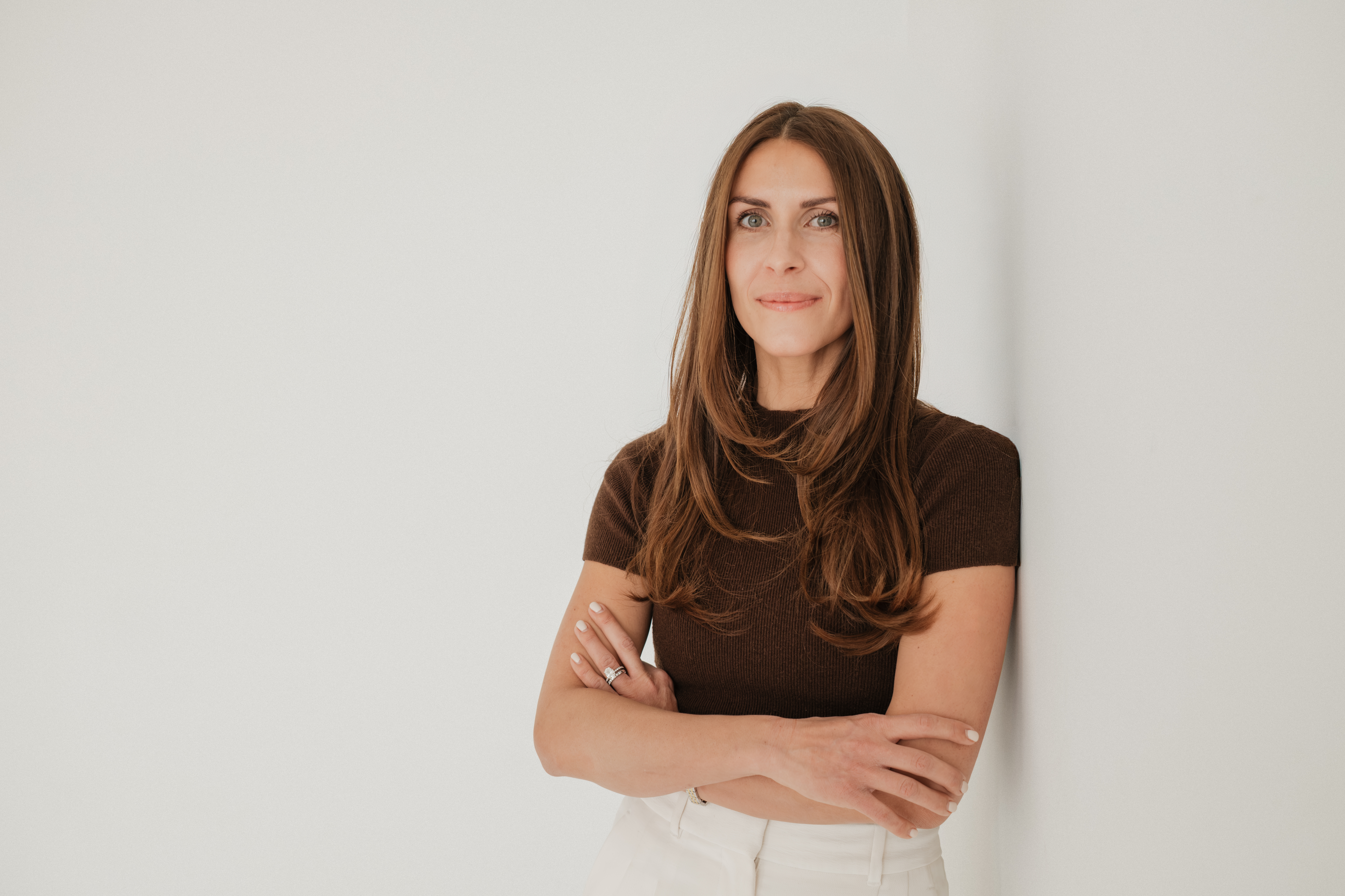 Professional brand photography session for small business owner on the North Shore MA, showing confident female entrepreneur with natural light studio portraits